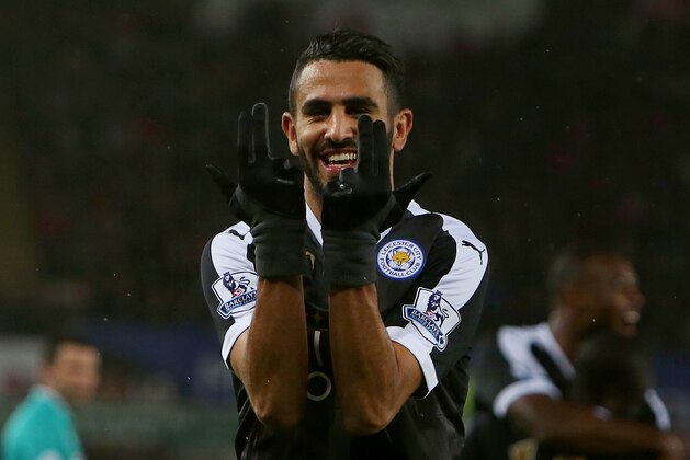 Leicester City's Algerian midfielder Riyad Mahrez celebrates after scoring his third goal during the English Premier League football match between Swansea City and Leicester City at The Liberty Stadium in Swansea, south Wales on December 5, 2015. AFP PHOTO / GEOFF CADDICK
RESTRICTED TO EDITORIAL USE. No use with unauthorized audio, video, data, fixture lists, club/league logos or 'live' services. Online in-match use limited to 75 images, no video emulation. No use in betting, games or single club/league/player publications. / AFP / GEOFF CADDICK (Photo credit should read GEOFF CADDICK/AFP/Getty Images) Leicester City's Algerian midfielder Riyad Mahrez celebrates after scoring his third goal during the English Premier League football match between Swansea City and Leicester City at The Liberty Stadium in Swansea, south Wales on December 5, 2015. AFP PHOTO / GEOFF CADDICK
RESTRICTED TO EDITORIAL USE. No use with unauthorized audio, video, data, fixture lists, club/league logos or 'live' services. Online in-match use limited to 75 images, no video emulation. No use in betting, games or single club/league/player publications. / AFP / GEOFF CADDICK (Photo credit should read GEOFF CADDICK/AFP/Getty Images)