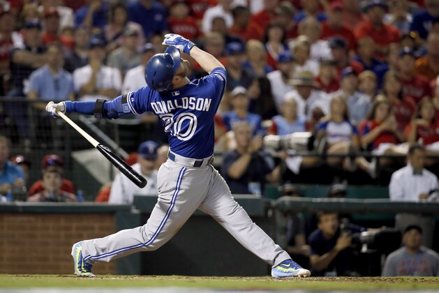 Toronto Blue Jays third baseman Josh Donaldson (20) swings against Texas Rangers during the sixth inning in Game 3 of baseball's American League Division Series Sunday, Oct. 11, 2015, in Arlington, Texas. (AP Photo/Tony Gutierrez)