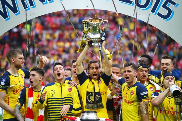 LONDON, ENGLAND - MAY 30:  Mathieu Flamini of Arsenal lifts the trophy in celebration with team mates after the FA Cup Final between Aston Villa and Arsenal at Wembley Stadium on May 30, 2015 in London, England. Arsenal beat Aston Villa 4-0.  (Photo by Clive Rose/Getty Images)
