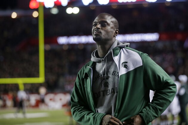 Former NFL player Plaxico Antonio Burress, who played college football at Michigan State, stands on the sidelines during an NCAA college football game between Rutgers and Michigan State Saturday, Oct. 10, 2015, in Piscataway, N.J. (AP Photo/Mel Evans)