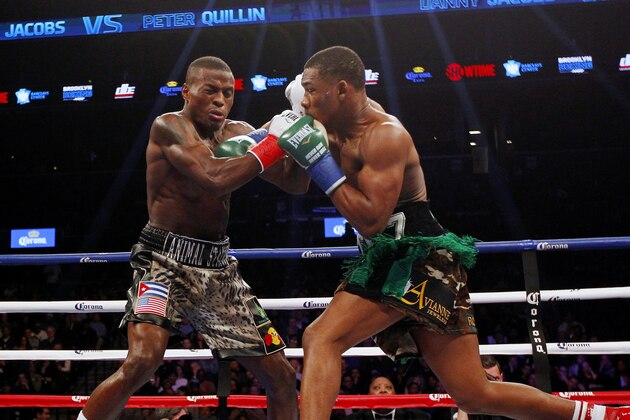 Peter Quillin, left, exchanges punches with Daniel Jacobs in the WBA middleweight championship boxing bout in New York on Saturday, Dec. 5, 2015. Jacobs won by a knockout in the first round. (AP Photo/Rich Schultz)