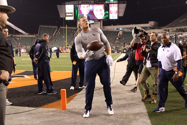 CINCINNATI, OH - NOVEMBER 16:  J.J. Watt #99 of the Houston Texans throws a football to a fan in the stands during the pre game warmups prior to the start of the game against the Cincinnati Bengals at Paul Brown Stadium on November 16, 2015 in Cincinnati, Ohio. (Photo by John Grieshop/Getty Images)