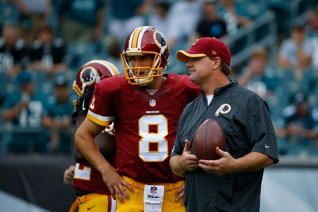 Washington Redskins' Kirk Cousins, left, and head coach Jay Gruden talk before an NFL football game against the Philadelphia Eagles, Sunday, Sept. 21, 2014, in Philadelphia. (AP Photo/Matt Rourke)