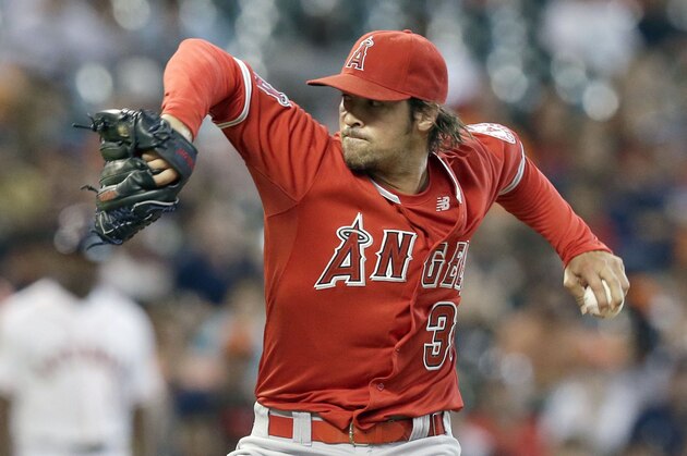 Los Angeles Angels' C.J. Wilson delivers a pitch against the Houston Astros in the first inning of a baseball game Tuesday, July 28, 2015, in Houston. (AP Photo/Pat Sullivan)