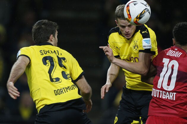Dortmund's midfielder Sven Bender (C) heads the ball past Stuttgart's midfielder Daniel Didavi (R) during the German first division Bundesliga football match Borussia Dortmund vs VfB Stuttgart, in Dortmund, western Germany, on November 29, 2015. Dortmund won the match 4-1.  AFP PHOTO / NORBERT SCHMIDT

RESTRICTIONS: DURING MATCH TIME: DFL RULES TO LIMIT THE ONLINE USAGE TO 15 PICTURES PER MATCH AND FORBID IMAGE SEQUENCES TO SIMULATE VIDEO. 
==RESTRICTED TO EDITORIAL USE ==
FOR FURTHER QUERIES PLEASE CONTACT THE DFL DIRECTLY AT + 49 69 650050. / AFP / NORBERT SCHMIDT        (Photo credit should read NORBERT SCHMIDT/AFP/Getty Images)