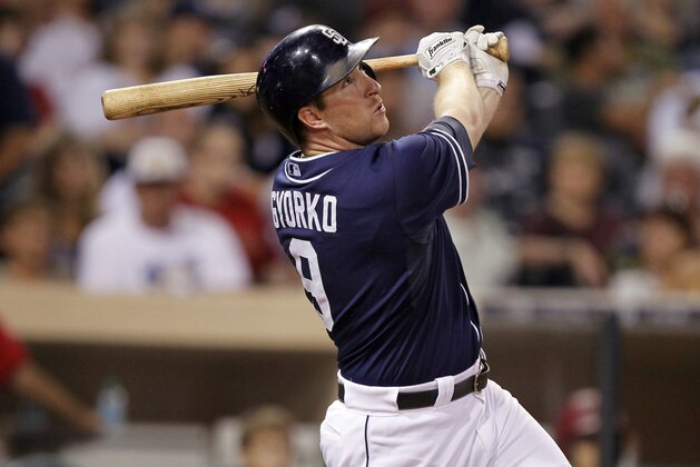 San Diego Padres' Jedd Gyorko hits an RBI sacrifice fly to score Cory Spangenberg against the Arizona Diamondbacks during the sixth inning of a baseball game in San Diego, Saturday, Sept. 26, 2015. (AP Photo/Alex Gallardo)