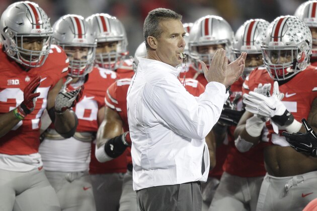 FILE - In this Nov. 7, 2015 file photo, Ohio State head coach Urban Meyer is surrounded by players during an NCAA college football game against Minnesota, in Columbus, Ohio.  Ohio State will face Illinois on Saturday Nov. 14, 2015 in Champaign, Ill. (AP Photo/Jay LaPrete, File)