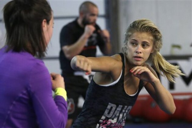 FILE - In this Monday, April 13, 2015, file photo, mixed martial arts fighter Paige VanZant, right, spars with Sarah Jamila at Ultimate Fitness in Sacramento, Calif. VanZant would love to be the next Ronda Rousey in the cage and on the silver screen, but the up-and-coming strawweight UFC fighter realizes she must do plenty of work to catch up to the dominant bantamweight champion. She takes her next step Saturday, Sept. 5, at UFC 191 in Las Vegas against Alex Chambers. (AP Photo/Rich Pedroncelli, File)