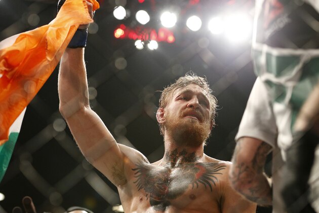 Conor McGregor celebrates after defeating Chad Mendes in their interim featherweight title mixed martial arts bout at UFC 189 Saturday, July 11, 2015, in Las Vegas. (AP Photo/John Locher)