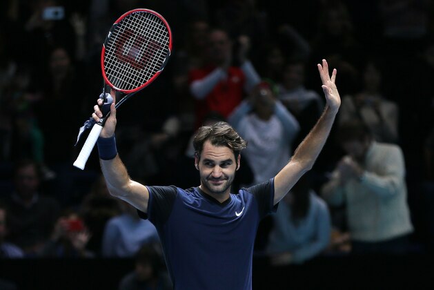 Switzerland's Roger Federer celebrates winning match point against Switzerland's Stan Wawrinka in their ATP World Tour Finals semifinal tennis match at the O2 Arena in London, Saturday Nov. 21, 2015. (AP Photo/Tim Ireland)