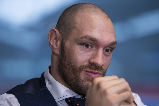 Newly crowned heavyweight world boxing champion Tyson Fury waits to answer questions as he hosts a media day in Bolton, England, Monday, Nov. 30, 2015. The 27-year-old Briton defeated 39-year-old Ukrainian Wladimir Klitschko in Dusseldorf, Germany on Saturday to become the WBA, IBF and WBO heavyweight champion. (AP Photo/Jon Super)