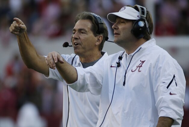 Alabama head coach Nick Saban, left, and defensive coordinator Kirby Smart call in a defense during the second half of an NCAA college football game against Tennessee in Tuscaloosa, Ala., Saturday, Oct. 26, 2013. (AP Photo/Dave Martin)