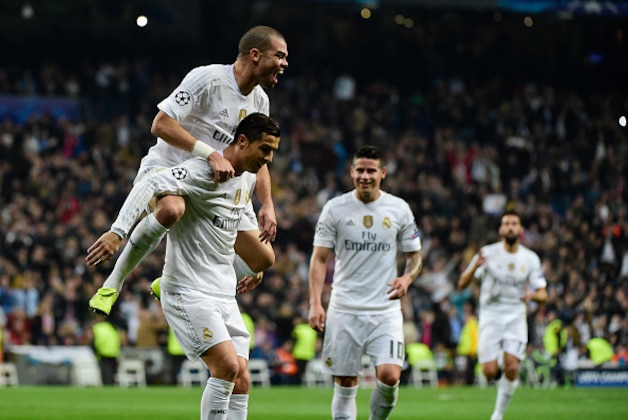 Real Madrid's Portuguese forward Cristiano Ronaldo (R) celebrates with Real Madrid's Portuguese defender Pepe after scoring during the UEFA Champions League Group A football match Real Madrid CF vs Malmo FF at the Santiago Bernabeu stadium in Madrid on December 8, 2015.   AFP PHOTO/ PIERRE-PHILIPPE MARCOU / AFP / PIERRE-PHILIPPE MARCOU        (Photo credit should read PIERRE-PHILIPPE MARCOU/AFP/Getty Images)