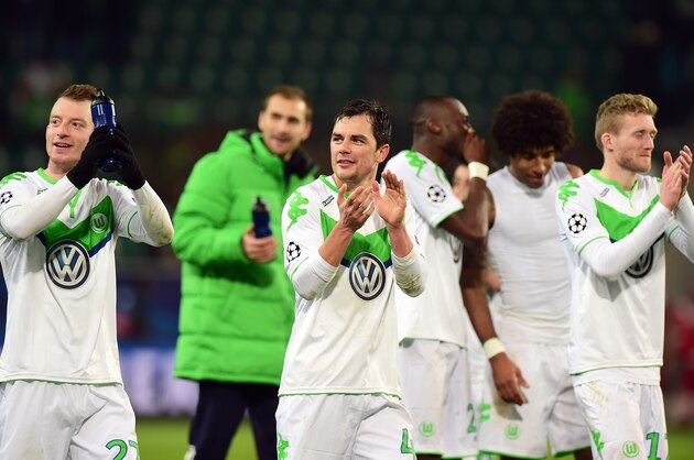 (L-R) Wolfsburg's midfielder Maximilian Arnold , Wolfsburg's defender Marcel Schaefer, Wolfsburg's striker Andre Schuerrle celebrate after the UEFA Champions League Group B second-leg football match VfL Wolfsburg vs Manchester United in Wolfsburg, central Germany, on December 8, 2015. Manchester United crashed out of the Champions League on Tuesday with a 3-2 defeat at Wolfsburg, who made club history by reaching the knock-out stages. AFP PHOTO / JOHN MACDOUGALL / AFP / JOHN MACDOUGALL        (Photo credit should read JOHN MACDOUGALL/AFP/Getty Images)