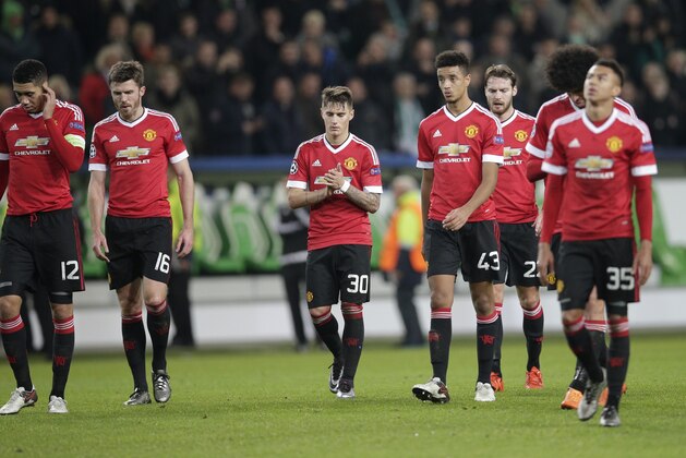 Manchester United players leave the pitch after their team was eliminated from the Champions League by losing 3-2 to Wolfsburg during the Champions League group B soccer match between VfL Wolfsburg and Manchester United in Wolfsburg, Germany, Tuesday, Dec. 8, 2015. (AP Photo/Michael Sohn)
