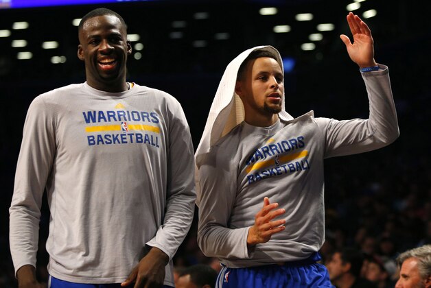 Dec 6, 2015; Brooklyn, NY, USA;  Golden State Warriors forward Draymond Green (23) and Golden State Warriors guard Stephen Curry (30) react after a three point shot by Golden State during the second half at Barclays Center. The Golden State Warriors defeated the Brooklyn Nets 114-98. Mandatory Credit: Noah K. Murray-USA TODAY Sports