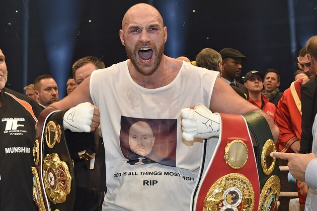 FOR USE AS DESIRED, YEAR END PHOTOS - FILE - Britain's new world boxing champion Tyson Fury celebrates with the WBA, IBF, WBO and IBO belts after winning the world heavyweight title fight against Ukraine's Wladimir Klitschko in the Esprit Arena in Duesseldorf, western Germany, Sunday, Nov. 29, 2015. (AP Photo/Martin Meissner, File)