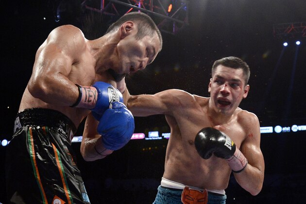 Omar Figueroa, Jr., right, hits Nihito Arakawa, of Japan, during a lightweight title boxing match, Saturday, July 27, 2013, in San Antonio. Figueroa won by decision after 12 rounds. (AP Photo/Darren Abate)