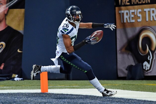 Sep 13, 2015; St. Louis, MO, USA; Seattle Seahawks defensive back Cary Williams (26) scores after forcing St. Louis Rams quarterback Nick Foles (not pictured) to fumble the ball during the second half at the Edward Jones Dome. Mandatory Credit: Jasen Vinlove-USA TODAY Sports
