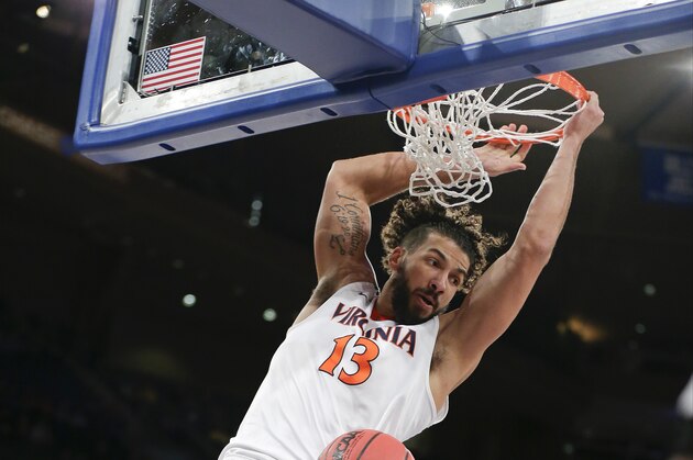 Virginia's Anthony Gill (13) dunks the ball as West Virginia's Daxter Miles Jr. (4) watches during the first half of an NCAA college basketball game, Tuesday, Dec. 8, 2015, in New York. (AP Photo/Frank Franklin II)