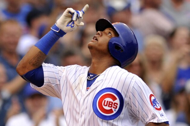 Chicago Cubs' Starlin Castro (13), points skyward at home plate after hitting a two-run home run during the fifth inning of a baseball game against the St. Louis Cardinals Friday, Sept. 18, 2015 in Chicago. (AP Photo/Paul Beaty)