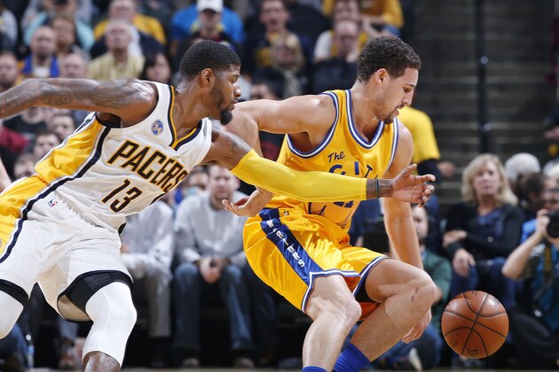 INDIANAPOLIS, IN - DECEMBER 8: Klay Thompson #11 of the Golden State Warriors goes for a loose ball against Paul George #13 of the Indiana Pacers in the first half of the game at Bankers Life Fieldhouse on December 8, 2015 in Indianapolis, Indiana. NOTE TO USER: User expressly acknowledges and agrees that, by downloading and or using the photograph, User is consenting to the terms and conditions of the Getty Images License Agreement. (Photo by Joe Robbins/Getty Images)