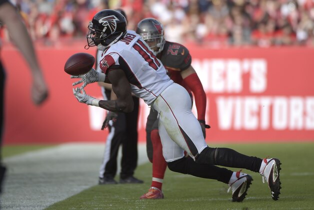 Atlanta Falcons wide receiver Julio Jones (11) juggles a pass in front of Tampa Bay Buccaneers cornerback Sterling Moore (26) during the third quarter of an NFL football game Sunday, Dec. 6, 2015, in Tampa, Fla. (AP Photo/Phelan M. Ebenhack)