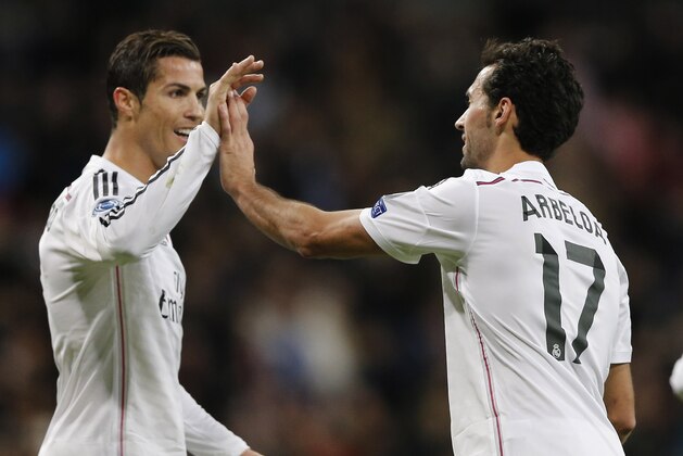 Real Madrid's Alvaro Arbeloa celebrates scoring his side's 3rd goal with Cristiano Ronaldo during a Group B Champions League soccer match between Real Madrid and Ludogorets at the Santiago Bernabeu stadium in Madrid, Spain, Tuesday Dec. 9, 2014. (AP Photo/Daniel Ochoa de Olza)