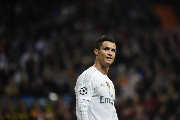 Real Madrid's Portuguese forward Cristiano Ronaldo smiles during the UEFA Champions League Group A football match Real Madrid CF vs Malmo FF at the Santiago Bernabeu stadium in Madrid on December 8, 2015.   AFP PHOTO/ PIERRE-PHILIPPE MARCOU / AFP / PIERRE-PHILIPPE MARCOU        (Photo credit should read PIERRE-PHILIPPE MARCOU/AFP/Getty Images)