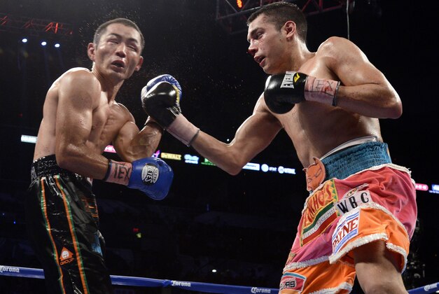 Omar Figueroa, Jr., right, hits Nihito Arakawa, of Japan, during a lightweight title boxing match, Saturday, July 27, 2013, in San Antonio. Figueroa won by decision after 12 rounds. (AP Photo/Darren Abate)