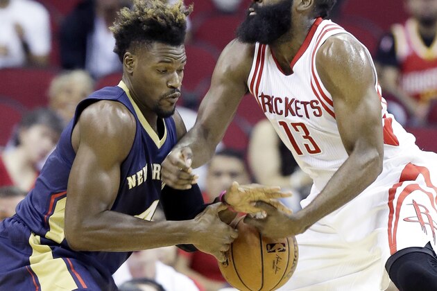 Houston Rockets' James Harden (13) and New Orleans Pelicans' Jeff Adrien grab for the ball in the first half of a preseason NBA basketball game Monday, Oct. 19, 2015, in Houston. (AP Photo/Pat Sullivan)