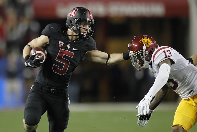 Dec 5, 2015; Santa Clara, CA, USA; Stanford Cardinal running back Christian McCaffrey (5) tries to avoid being tackled by Southern California Trojans cornerback Kevon Seymour (13) after running for a first down in the second quarter in the Pac-12 Conference football championship game at Levi's Stadium. Mandatory Credit: Cary Edmondson-USA TODAY Sports