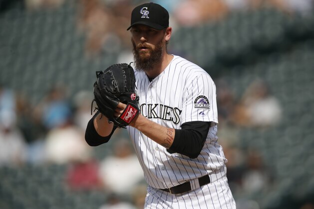 Colorado Rockies relief pitcher John Axford (66) works against the Arizona Diamondbacks in the ninth inning of a baseball game Thursday, June 25, 2015, in Denver. Colorado won 6-4. (AP Photo/David Zalubowski)