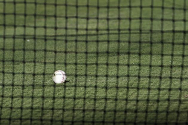 A ball is seen through the safety net before a baseball game between the Los Angeles Angels and the Texas Rangers on Friday, Sept. 6, 2013, in Anaheim, Calif. (AP Photo/Jae C. Hong)