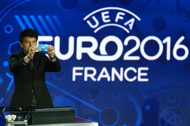 Russian former soccer goalkeeper Rinat Dasayev shows the draw of Spain, during the UEFA EURO 2016 qualifying draw ceremony at the Acropolis Convention Centre in Nice, southeastern France, Sunday, Feb 23, 2014.  (AP Photo/Lionel Cironneau)