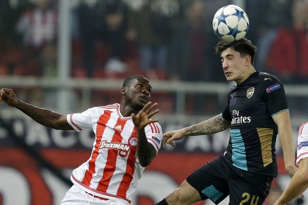 Olympiakos' Ideye Brown, left, fights for the ball with Arsenal's Hector Bellerin during the Champions League Group F soccer match between Olympiakos and Arsenal at Georgios Karaiskakis stadium in Piraeus port, near Athens, Wednesday, Dec. 9, 2015. (AP Photo/Thanassis Stavrakis)