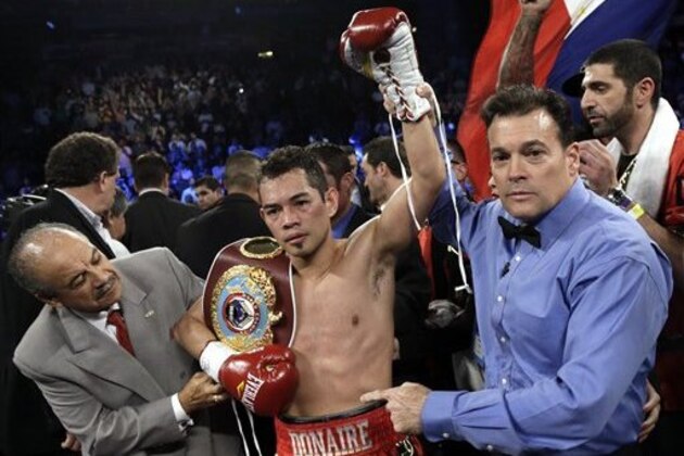 Nonito Donaire, center, celebrates as referee Laurence Cole, right, holds up his arm after beating Jorge Arce in their WBO junior featherweight title boxing match Saturday, Dec. 15, 2012, in Houston. Donaire knocked Arce out in the third round. (AP Photo/David J. Phillip)