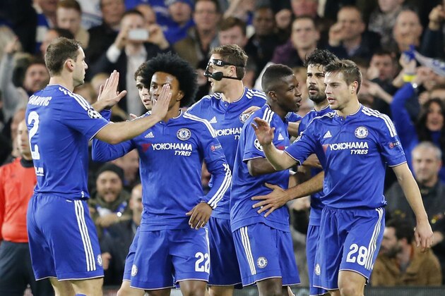 Chelsea players celebrate a goal by Chelsea's Diego Costa, background right, during the Champions League group G soccer match between Chelsea and FC Porto at Stamford Bridge stadium in London, Wednesday, Dec. 9, 2015.(AP Photo/Frank Augstein)