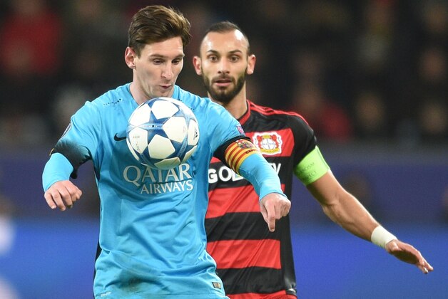 Leverkusen's Omer Toprak, right, and Barcelona's Lionel Messi challenge for the ball during the Champions League Group E soccer match between Bayer Leverkusen and FC Barcelona in Leverkusen, western Germany, Wednesday, Dec. 9, 2015. (AP Photo/Sebastian Konopka)