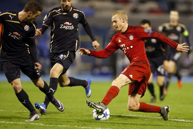 Bayern's Sebastian Rode, right, fights for the ball with Zagreb's Goncalo Santos, center and Ivo Pinto during the Champions League Group F soccer match between Dinamo Zagreb and Bayern Munich in Zagreb, Croatia, Wednesday, Dec. 9, 2015. (AP Photo/Darko Bandic)