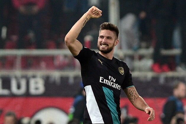 Arsenal's French forward Olivier Giroud celebrates scoring during the UEFA Champions League Group F football match between Olympiacos and Arsenal at the Georgios Karaiskakis Stadium in Piraeus near Athens on December 9, 2015. 
Arsenal won the match 0-3. / AFP / LOUISA GOULIAMAKI        (Photo credit should read LOUISA GOULIAMAKI/AFP/Getty Images)