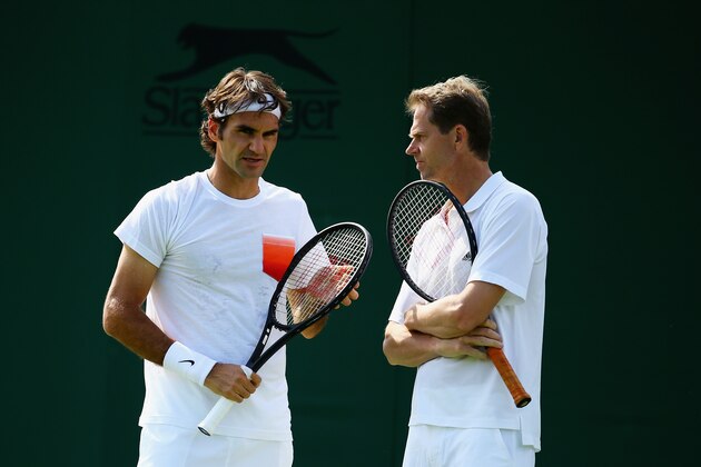 LONDON, ENGLAND - JUNE 21:  Roger Federer of Switzerland talks with his coach Stefan Edberg during a practice session during previews for Wimbledon Championships at Wimbledon on June 21, 2014 in London, England.  (Photo by Al Bello/Getty Images)