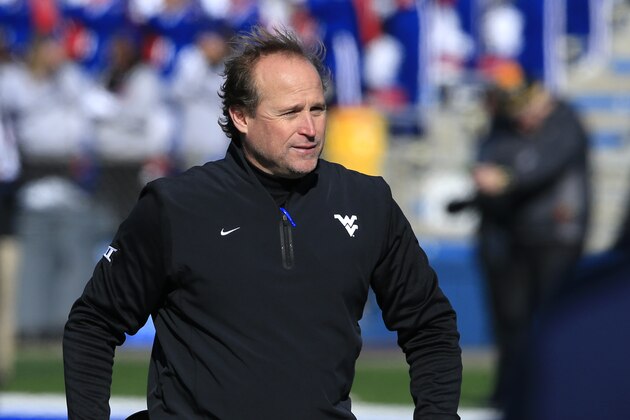 West Virginia head coach Dana Holgorsen walks the sidelines during the first half of an NCAA college football game against Kansas in Lawrence, Kan., Saturday, Nov. 21, 2015. (AP Photo/Orlin Wagner)