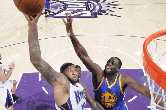 SACRAMENTO, CA - FEBRUARY 3: DeMarcus Cousins #15 of the Sacramento Kings rebounds against Draymond Green #23 of the Golden State Warriors on February 3, 2015 at Sleep Train Arena in Sacramento, California. NOTE TO USER: User expressly acknowledges and agrees that, by downloading and or using this photograph, User is consenting to the terms and conditions of the Getty Images Agreement. Mandatory Copyright Notice: Copyright 2015 NBAE (Photo by Rocky Widner/NBAE via Getty Images)