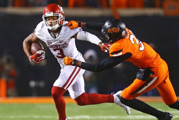 Nov 28, 2015; Stillwater, OK, USA; Oklahoma Sooners wide receiver Sterling Shepard (left) is pursued by Oklahoma State Cowboys safety Tre Flowers at Boone Pickens Stadium. The Sooners defeated the Cowboys 58-23. Mandatory Credit: Mark J. Rebilas-USA TODAY Sports