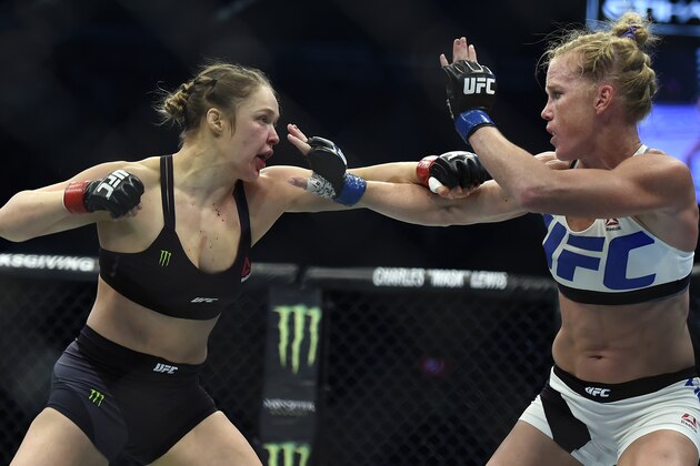 Ronda Rousey, left, and Holly Holm fight during their UFC 193 bantamweight title bout in Melbourne, Australia, Sunday, Nov. 15, 2015. Holm pulled off a stunning upset victory over Rousey in the fight, knocking out the women's bantamweight champion in the second round with a powerful kick to the head Sunday. (AP Photo/Andy Brownbill)
