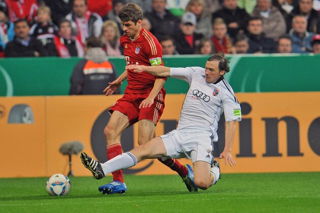 Munich's Thomas Mueller, left, challenges for the ball with Ingolstadt's Tobias Fink during the second round German soccer cup match (DFB Pokal) between  first division team of FC Bayern Munich and second-division club FC Ingolstadt in Munich, southern Germany, Wednesday, Oct. 26, 2011. (AP Photo/ Kerstin Joensson) NO MOBILE USE UNTIL 2 HOURS AFTER THE MATCH, WEBSITE USERS ARE OBLIGED TO COMPLY WITH DFB-RESTRICTIONS, SEE INSTRUCTIONS FOR DETAILS
