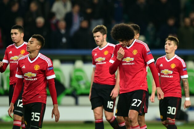 TOPSHOT - (L-R) Manchester United's English midfielder Jesse Lingard (35), Manchester United's Belgian midfielder Marouane Fellaini (27) react after the UEFA Champions League Group B second-leg football match VfL Wolfsburg vs Manchester United in Wolfsburg, central Germany, on December 8, 2015. Manchester United crashed out of the Champions League on Tuesday with a 3-2 defeat at Wolfsburg, who made club history by reaching the knock-out stages.  / AFP / JOHN MACDOUGALL        (Photo credit should read JOHN MACDOUGALL/AFP/Getty Images)
