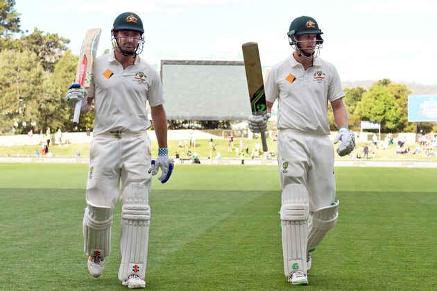 Australian batsmen Shaun Marsh (L) and Adam Voges (R) acknowledge the applause at the end of play on the first day of the first cricket Test match against the West Indies in Hobart on December 10, 2015.   AFP PHOTO / William WEST   --IMAGE RESTRICTED TO EDITORIAL USE - NO COMMERCIAL USE-- / AFP / WILLIAM WEST        (Photo credit should read WILLIAM WEST/AFP/Getty Images)