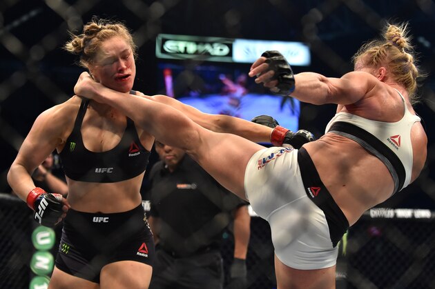 Holly Holm of the US (R) lands a kick to the neck to knock out compatriot Ronda Rousey and win the UFC title fight in Melbourne on November 15, 2015.   RESTRICTED TO EDITORIAL USE NO ADVERTISING USE NO PROMOTIONAL USE NO MERCHANDISING USE.   / AFP / PAUL CROCK        (Photo credit should read PAUL CROCK/AFP/Getty Images)